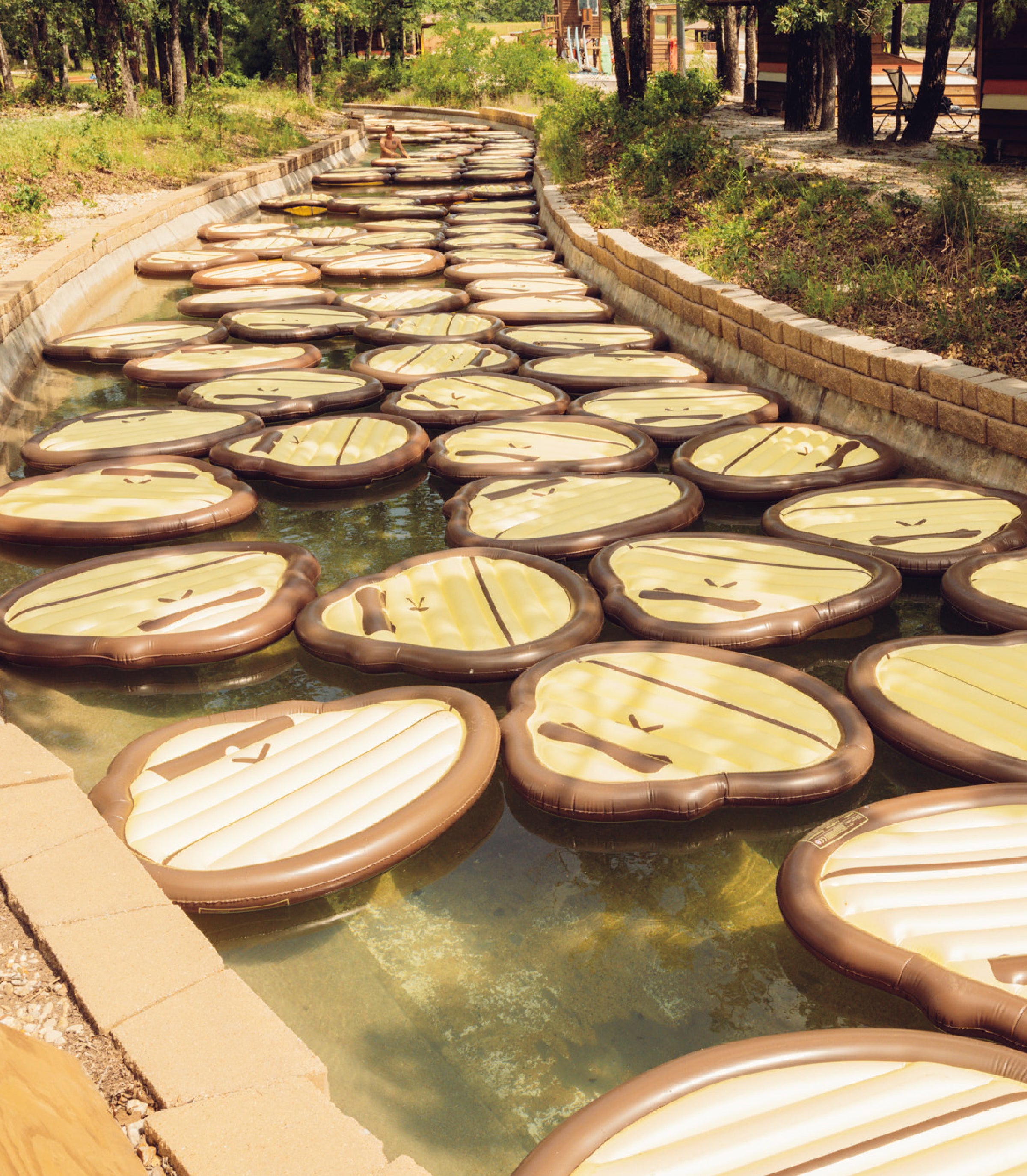 Decorative Sonny ape pool floats arranged in a pattern on a lazy river.