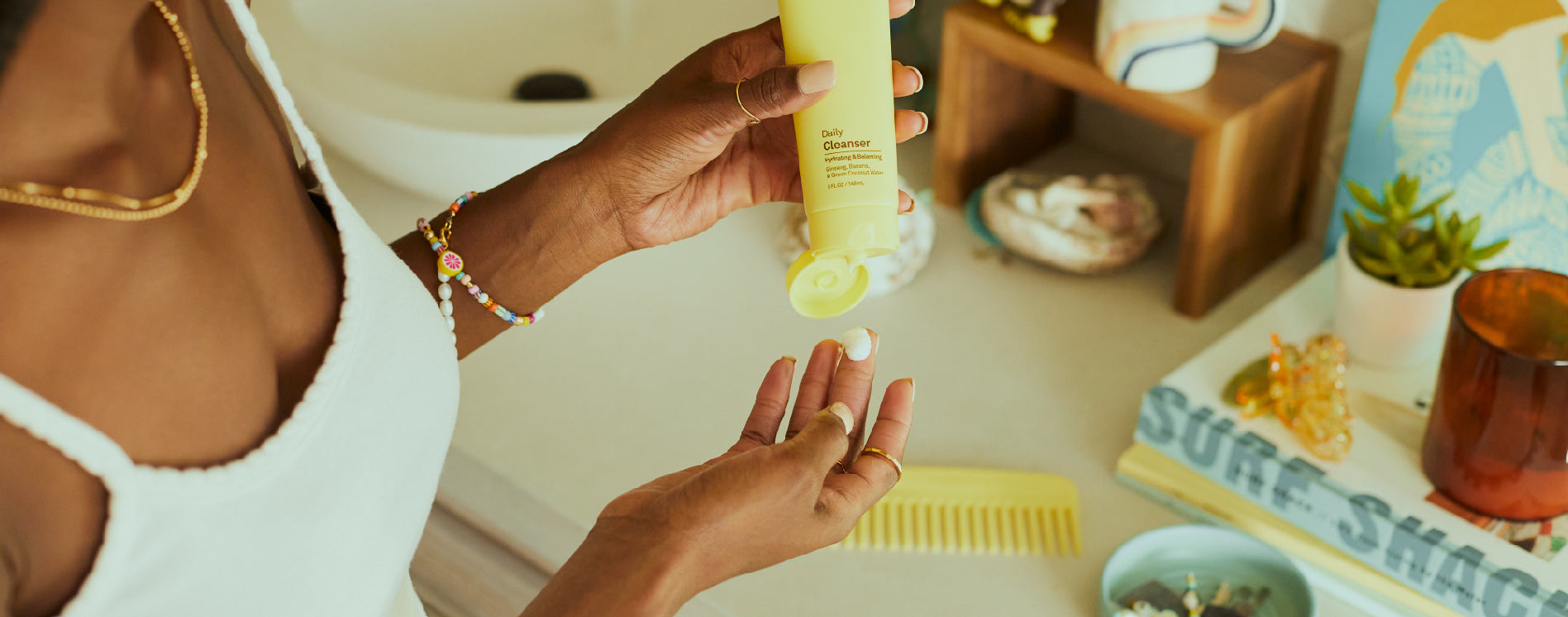 Girl applying Sun Bum Daily Cleanser into her palm