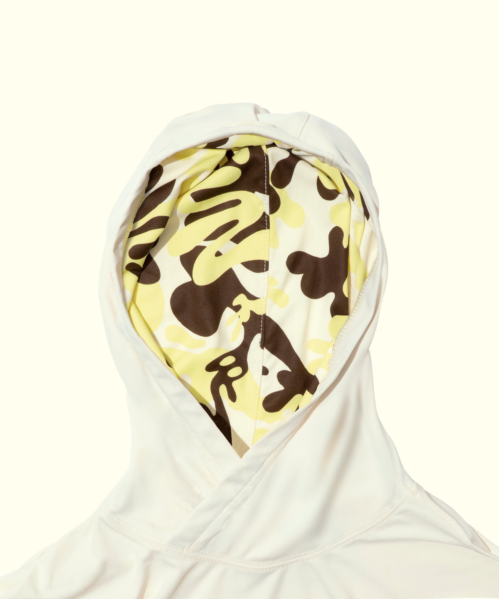 White hooded garment with a yellow and brown pattern on a white background