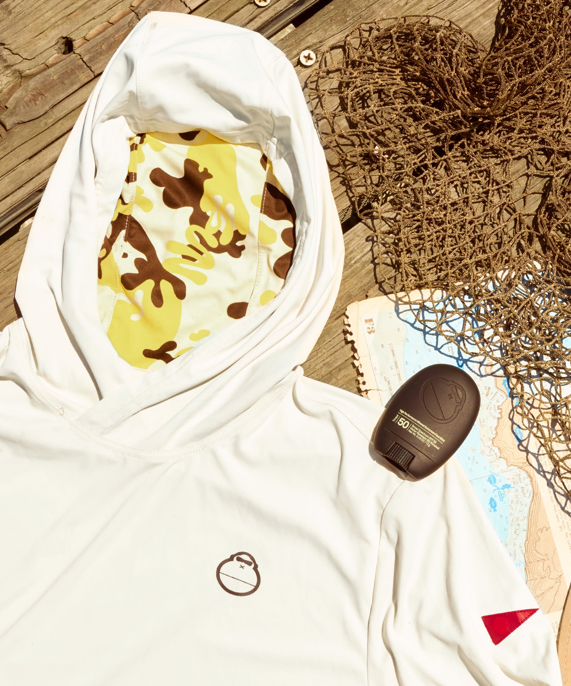 White hoodie with colorful design on a wooden surface