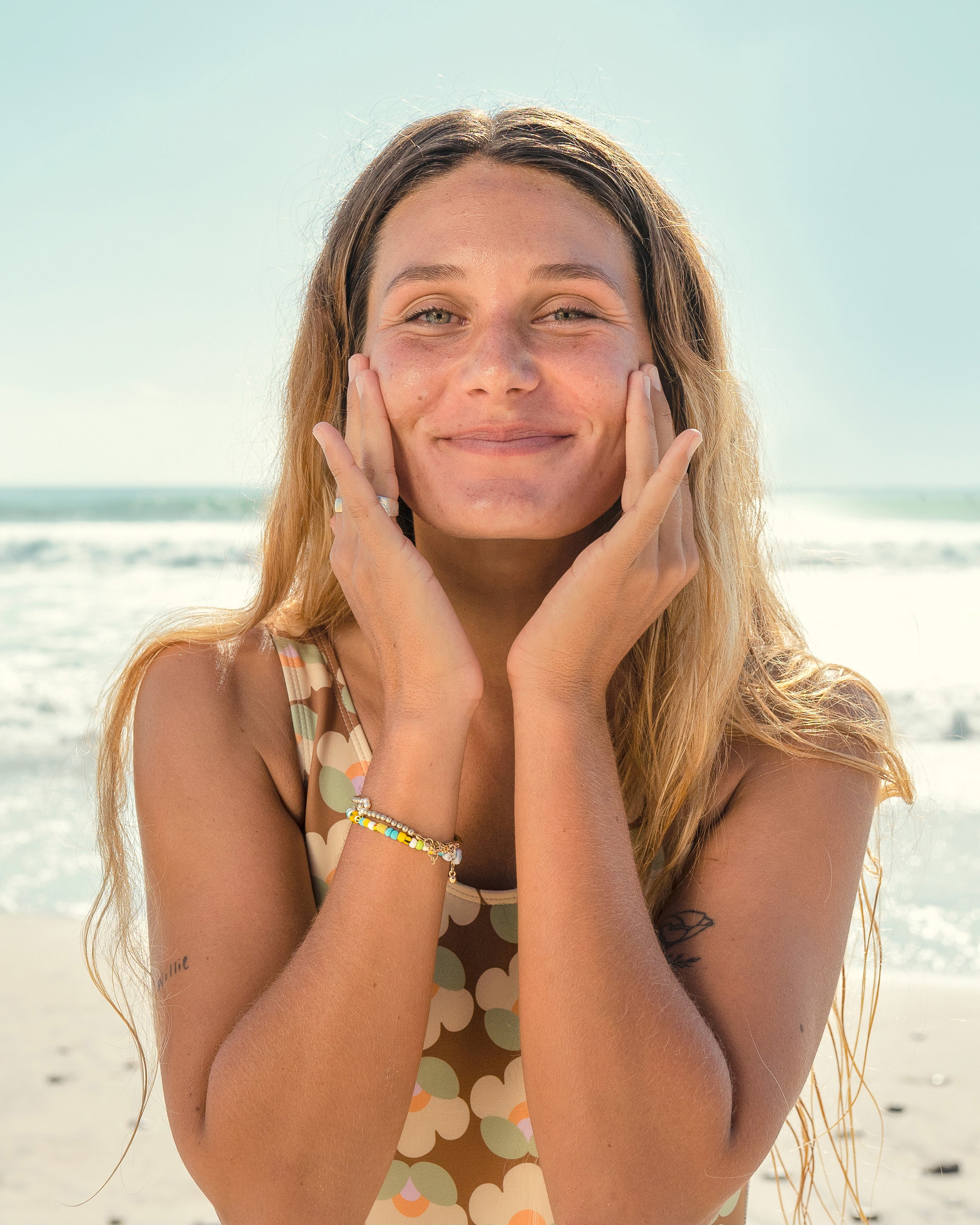 Woman applying Sun Bum skincare on her face 