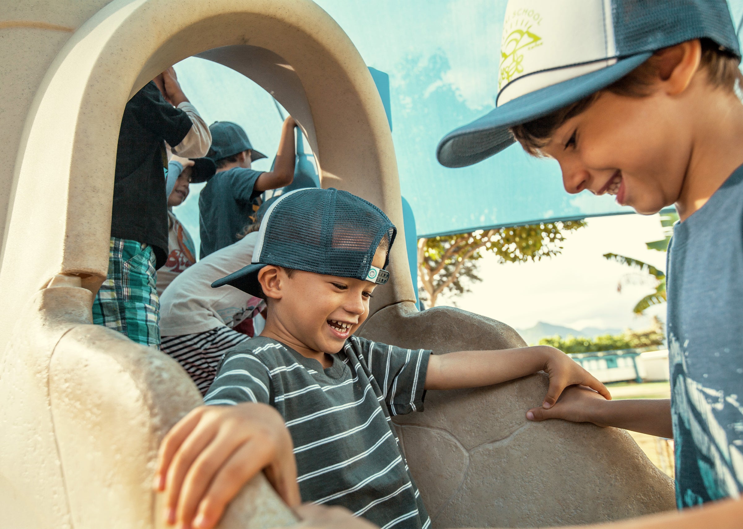 Man relaxing on a beach chair and umbrella balanced on a surfboard, showing creative sun protection from Know Your Spots Collection - Sun Bum.